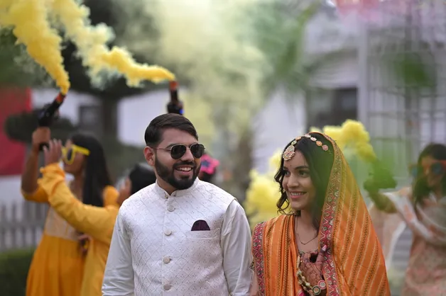 A candid photograph capturing joyful moments during the Haldi ceremony, taken by Fotographiya