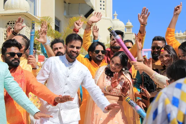 A candid photo capturing joyful moments during the Haldi ceremony, taken by Fotographiya