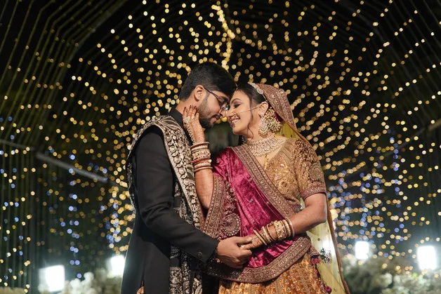 A candid portrait of the bride and groom sharing a heartfelt moment, captured by Fotographiya